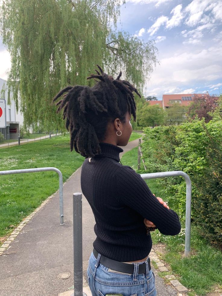 someone with freeform locs in a professional or polished setting
