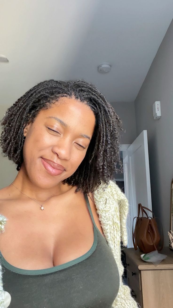 girl on locs smiling at the camera.