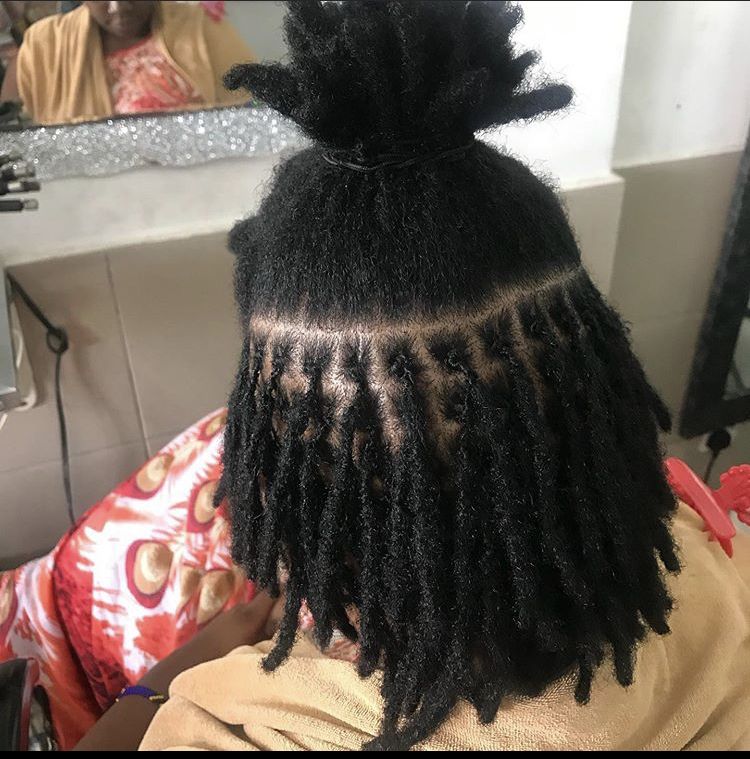 A girl in a salon to loc her hair