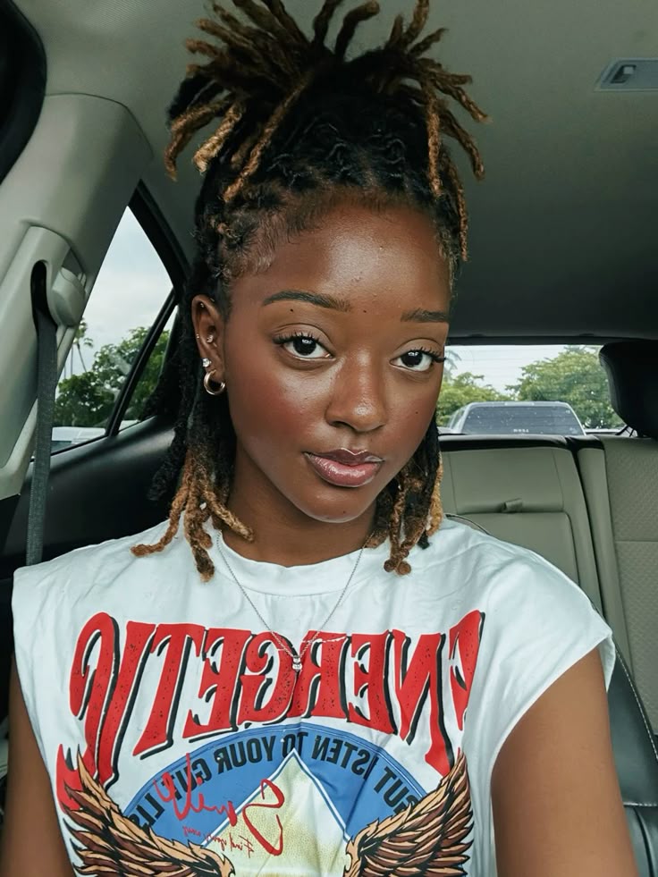A girl sitting in a car and pouting for a picture