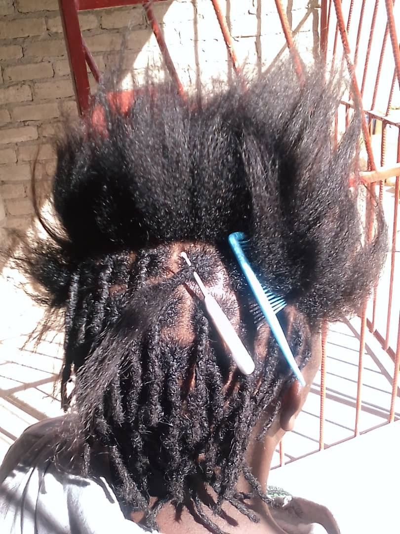 someone locing her hair