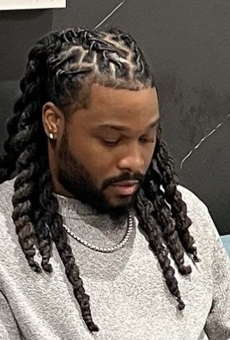 a man with a weaved locs
