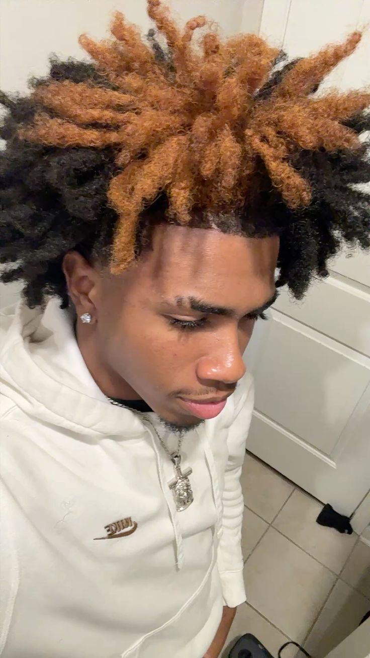 a man with black and brown colored locs