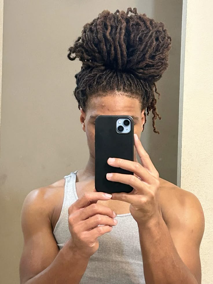 a man with a full bun locs